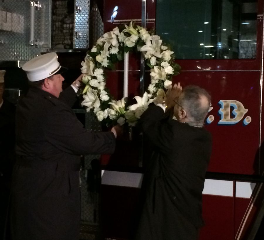 Chief Davis and Majid Sarmadi lay a wreath on Ladder 1