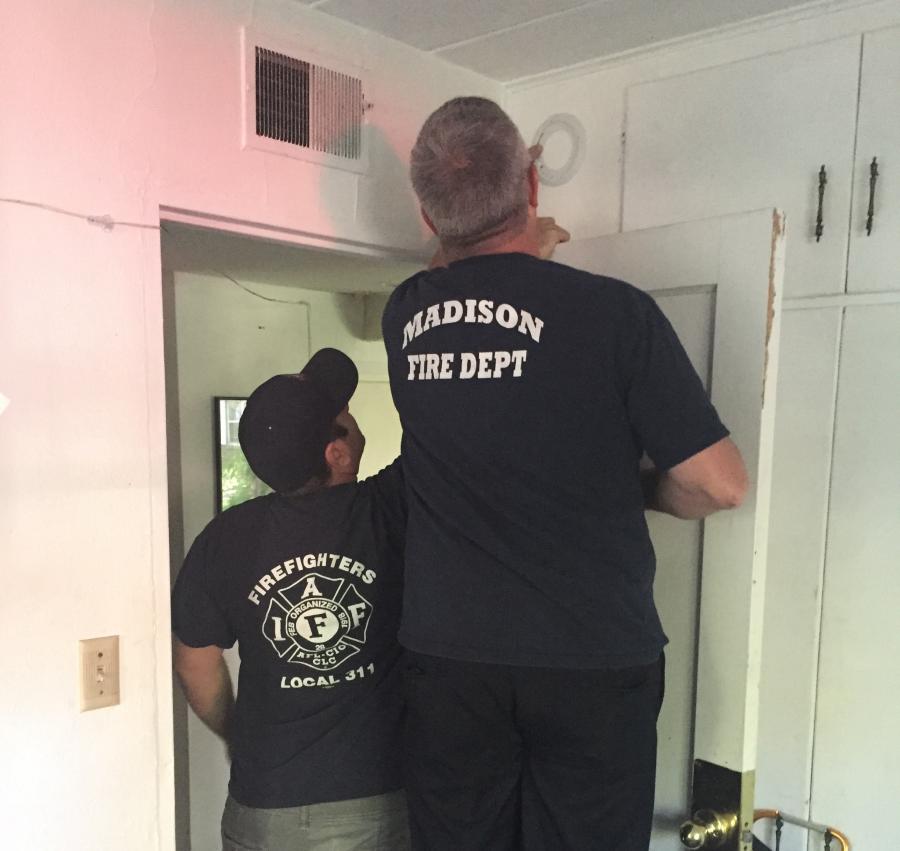 Firefighters install smoke detector
