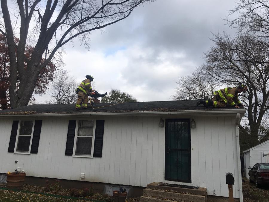 Firefighters cleaning roof
