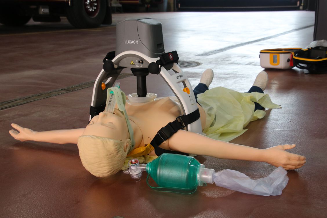 Manikin lying on floor with LUCAS device positioned on its chest