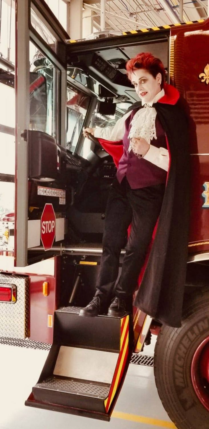 Firefighter Van Buskirk dressed as vampire by fire truck