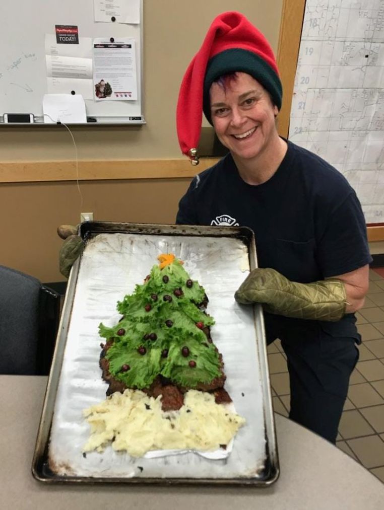 Firefighter Van Buskirk with meatloaf shaped like Christmas tree