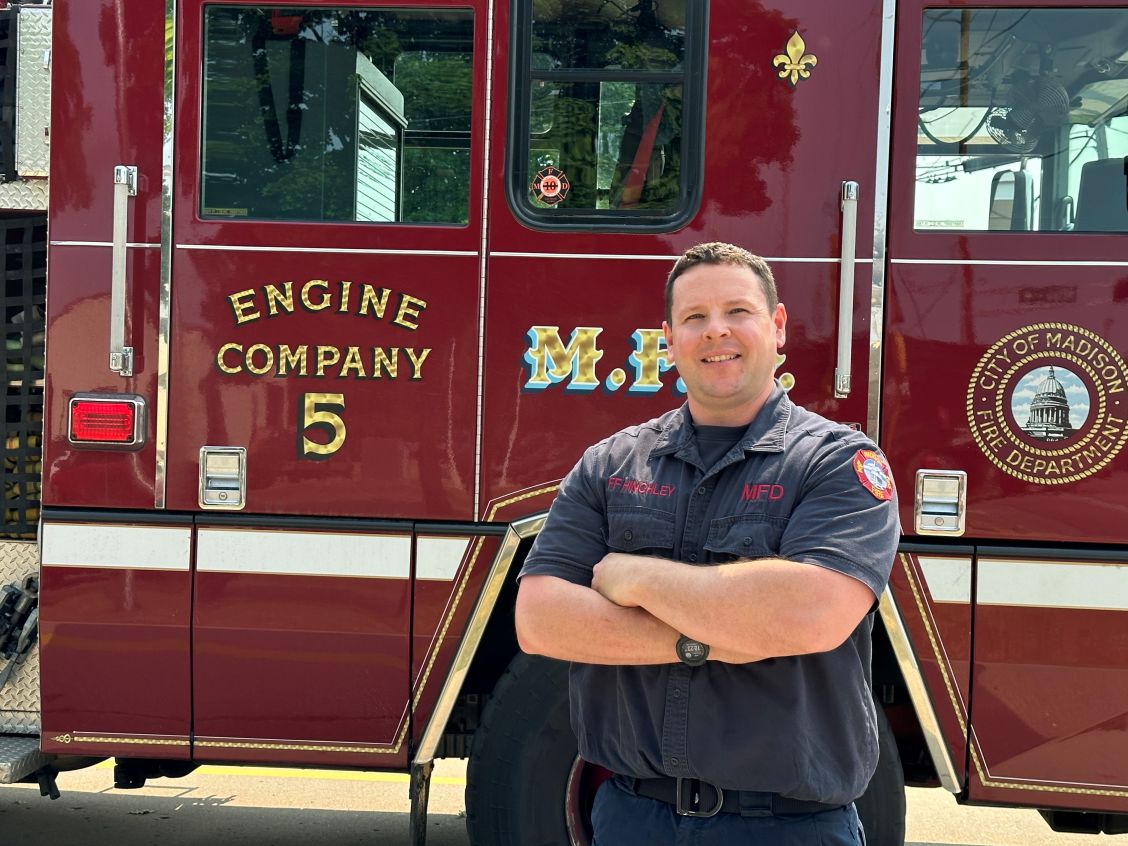 Firefighter/EMT Troy Hinchley standing next to Engine 5