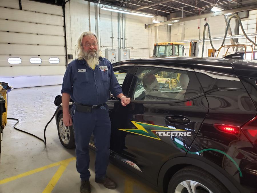 John in front of Part's Chevy Bolt