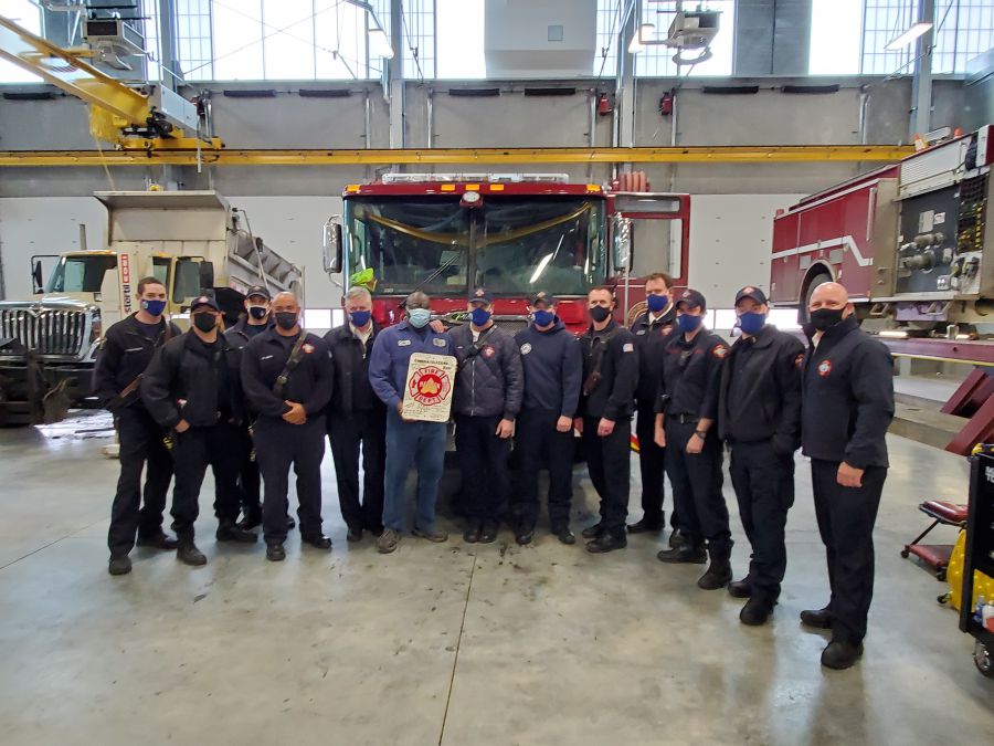 Edd receiving a plaque from members of the Madison Fire Department