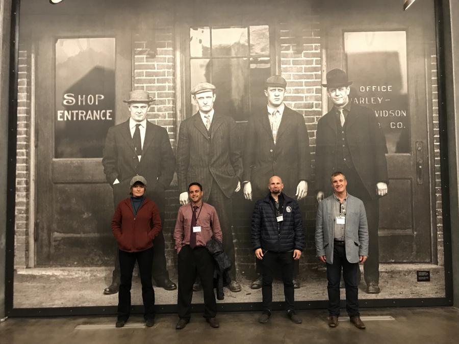 City staff posing with Harley Davidson founders photo