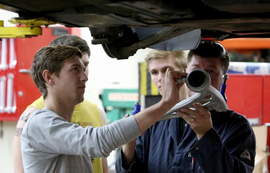 Student works with auto techer