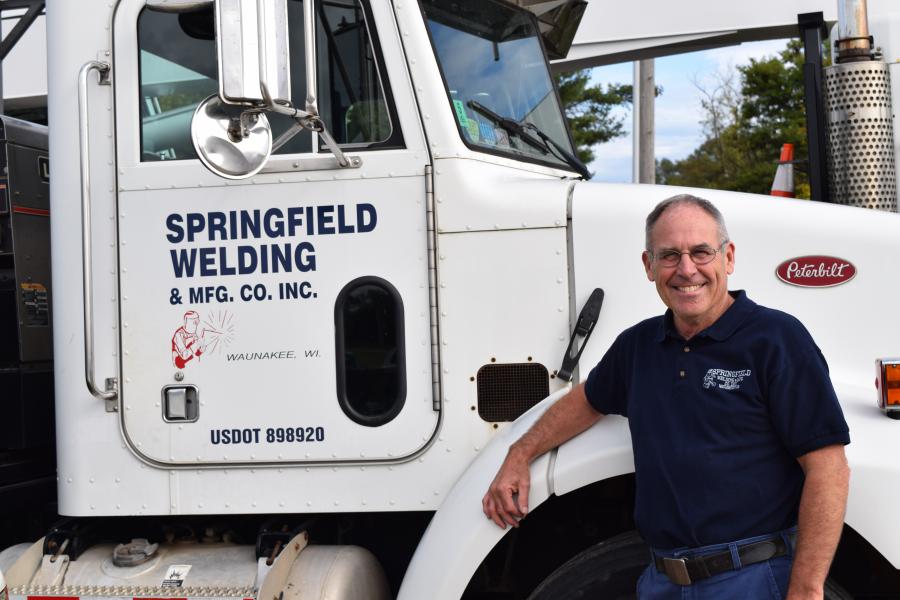 Gary Acker standing with Springfield Welding truck