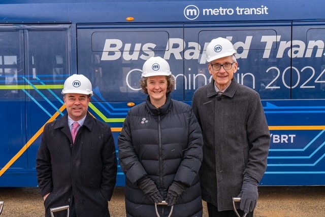 Mayor Rhodes-Conway with Governor Evers and Secretary Thompson in front of one of Madison's new electric buses at the BRT groundbreaking event