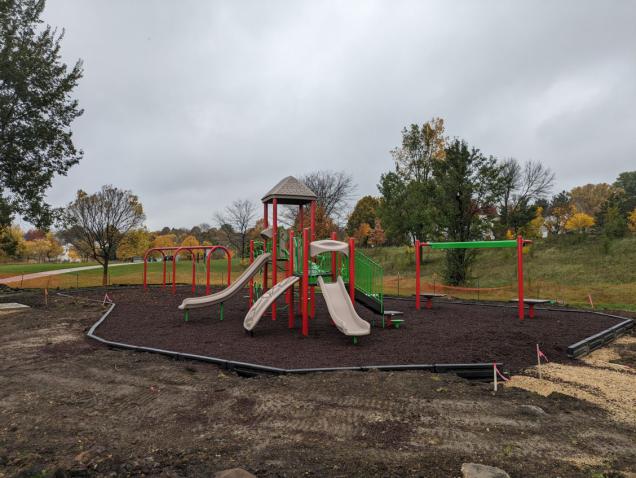 a photograph showing the playground equipment and surfacing at Maple Prairie Park on 10-27-2023
