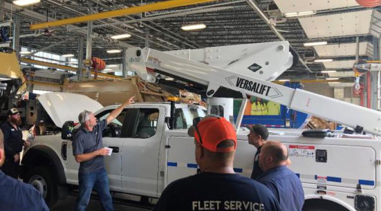 Employees receiving training on bucket trucks.
