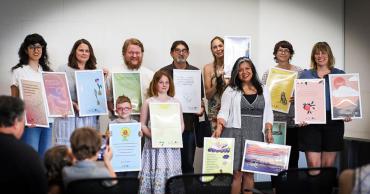 Image of selected poets with holding their poem designs. Photo credit: Sonia Villalobos