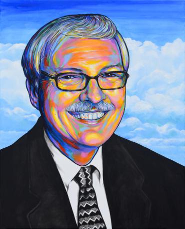 Photo realistic portrait of community servant and public leader Dick Wagner, painted in rainbow colors. Dick is pictured with a black suit jacket and black and white geometric tie. He is only visible above the chest. The background is light blue with white puffy clouds.