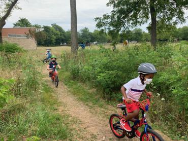 two children riding bikes on trail