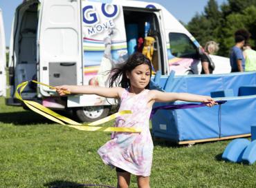 child dancing with ribbons