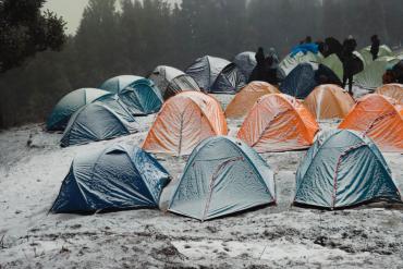 many snow-covered tents on snowy ground