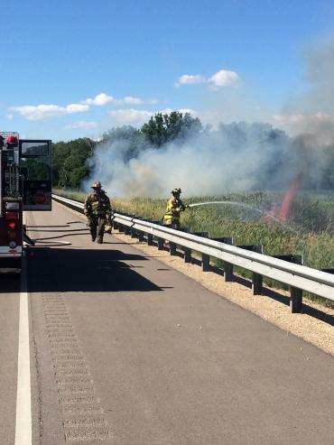 Firefighter douses brush fire
