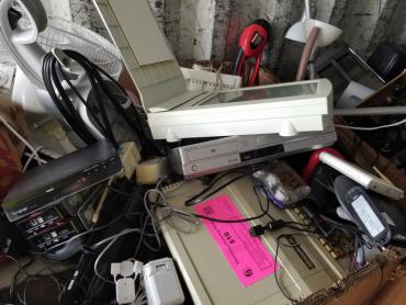 Pile of electronics, including a computer, at the drop-off site ready for recycling