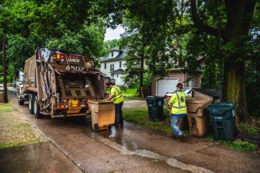 Two Streets Division employees emptying trash carts