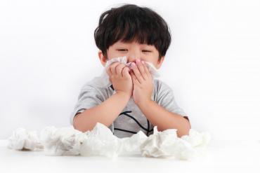 boy blowing nose