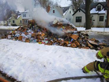 Pile of recyclables burning in the street near intersection of Lucia Crest and N. Blackhawk Ave