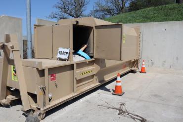 This is the trash compactor at Sycamore. It is tan.  But what will it's name be? Al Cubemaker? You tell us.