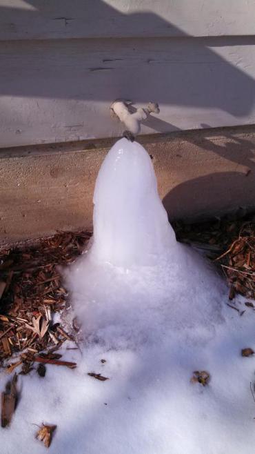 Frozen outdoor faucet due to being left on during frigid temperatures. 