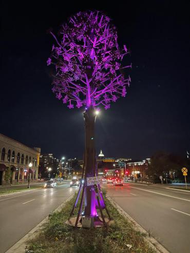 The sculpture CommuniTree is awash in purple lighting. Photo by Christopher Murphy