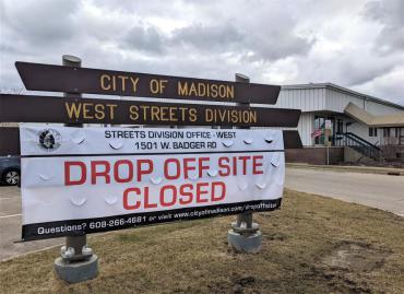 Photo of a large banner that says the drop-off site is closed at 1501 W. Badger Rd.