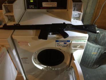 Black rifle on washing machine