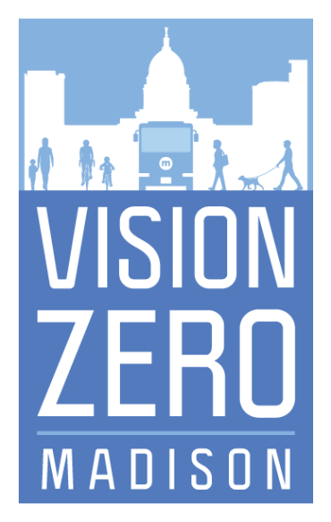 Logotipo azul y blanco que dice "Vision Zero" debajo de un gráfico de personas y un autobús frente a un fondo de ciudad.