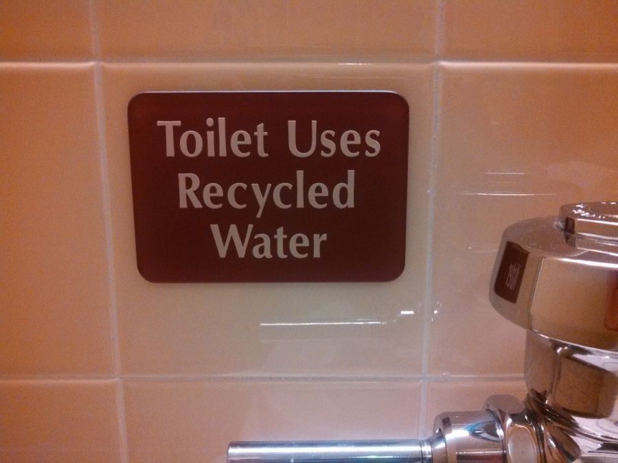 Toilet uses recycked water sign