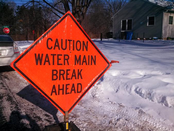 Caution water main break ahead sign