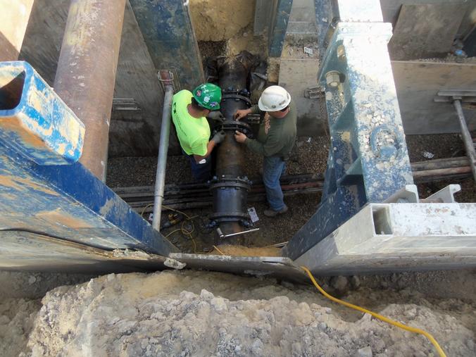 Crews install new pipe at construction site