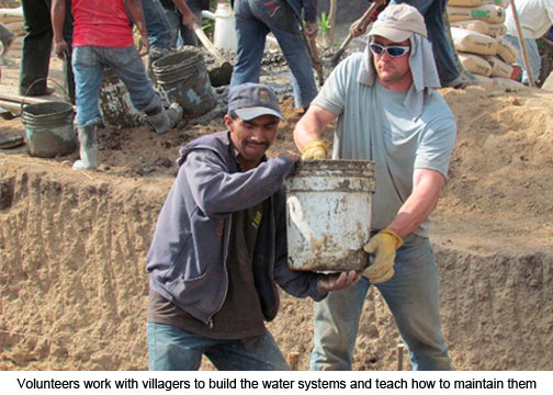 Volunteers work with villagers to build the water systems and teach how to maintain them