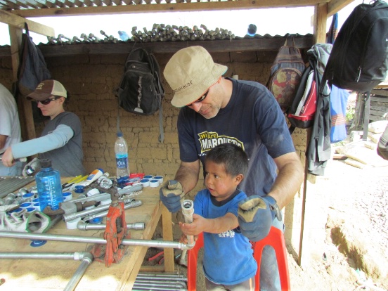 Volunteer helping a little boy